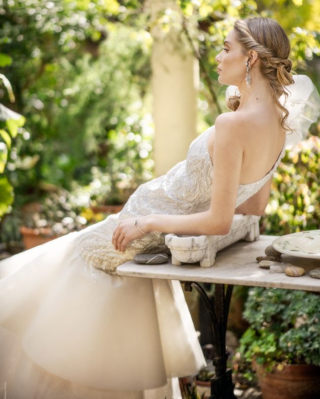 shine wedding dress open back woman leaning on marble table