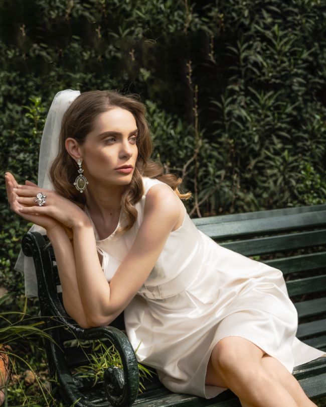 lady wedding dress woman leaning on bench