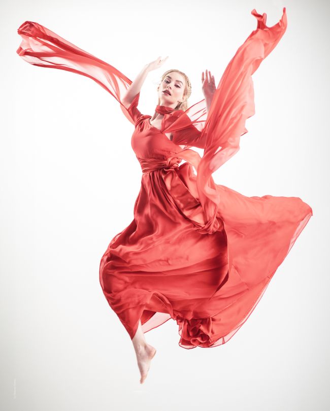 red dress woman jumping in the air