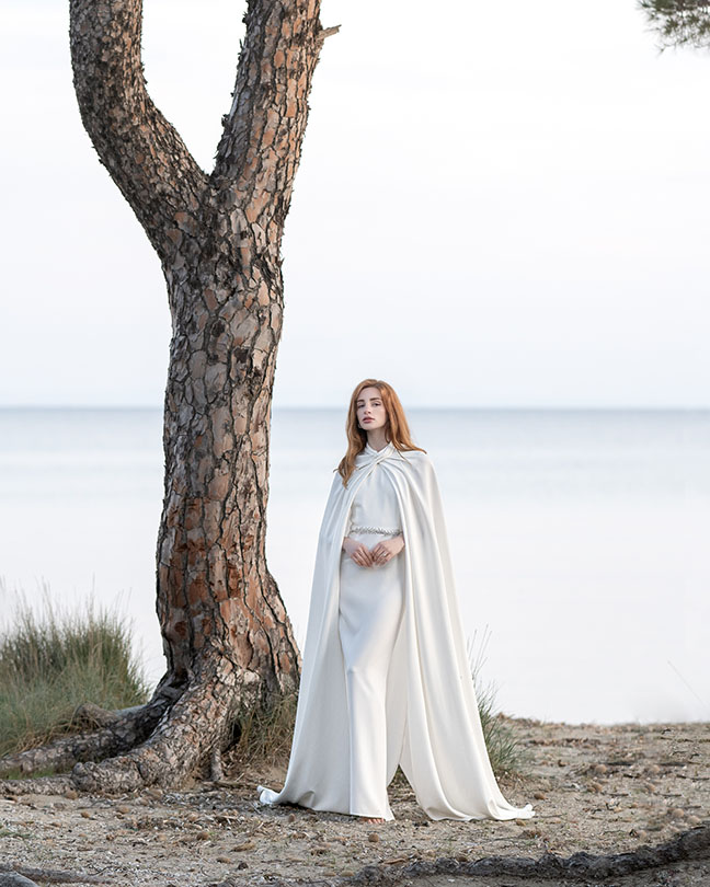 white queen wedding dress with cape